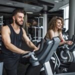 Gimnasios - Hombre y mujer haciendo ejercicios con un rutina fitness en uno de los mejores gimnasios en Barcelona
