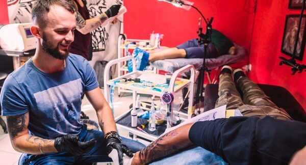 Tatuajes realistas - Tatuador profesional realizando un diseño de tatuajes en realismo a un hombre en Barcelona